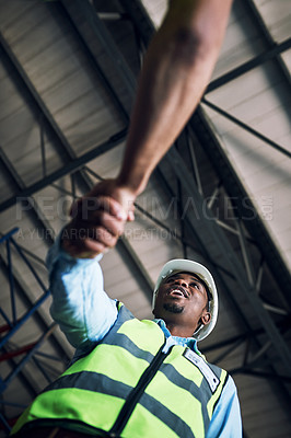 Buy stock photo Black man, architect and handshake for construction, building or hiring in teamwork partnership on site. Low angle of African male engineer shaking hands in recruiting, architecture agreement or deal