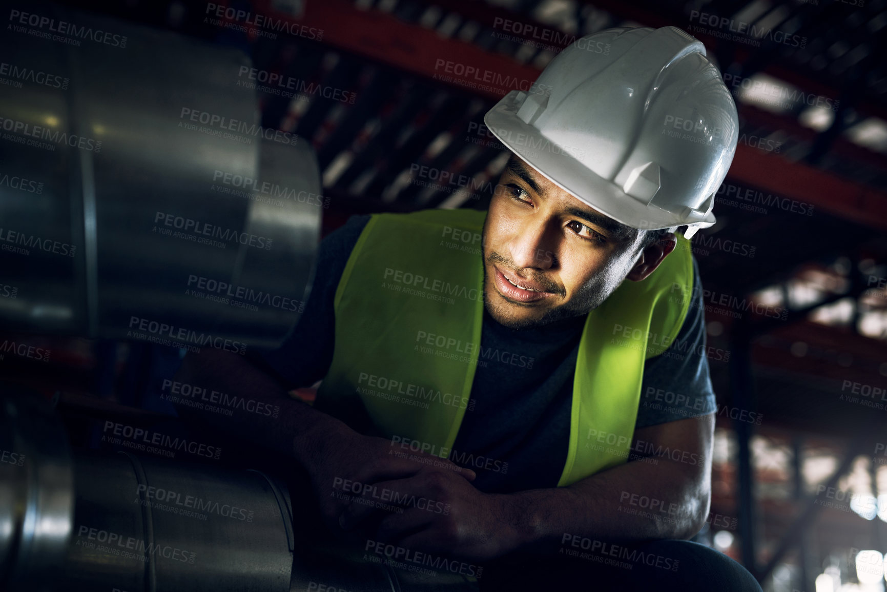 Buy stock photo Shot of a young man doing inspections at a construction site