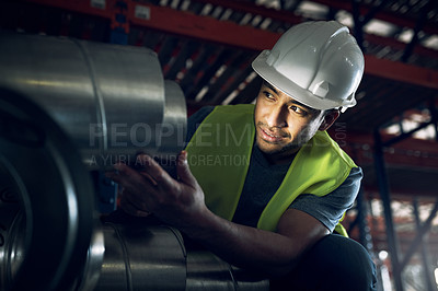 Buy stock photo Shot of a young man doing inspections at a construction site