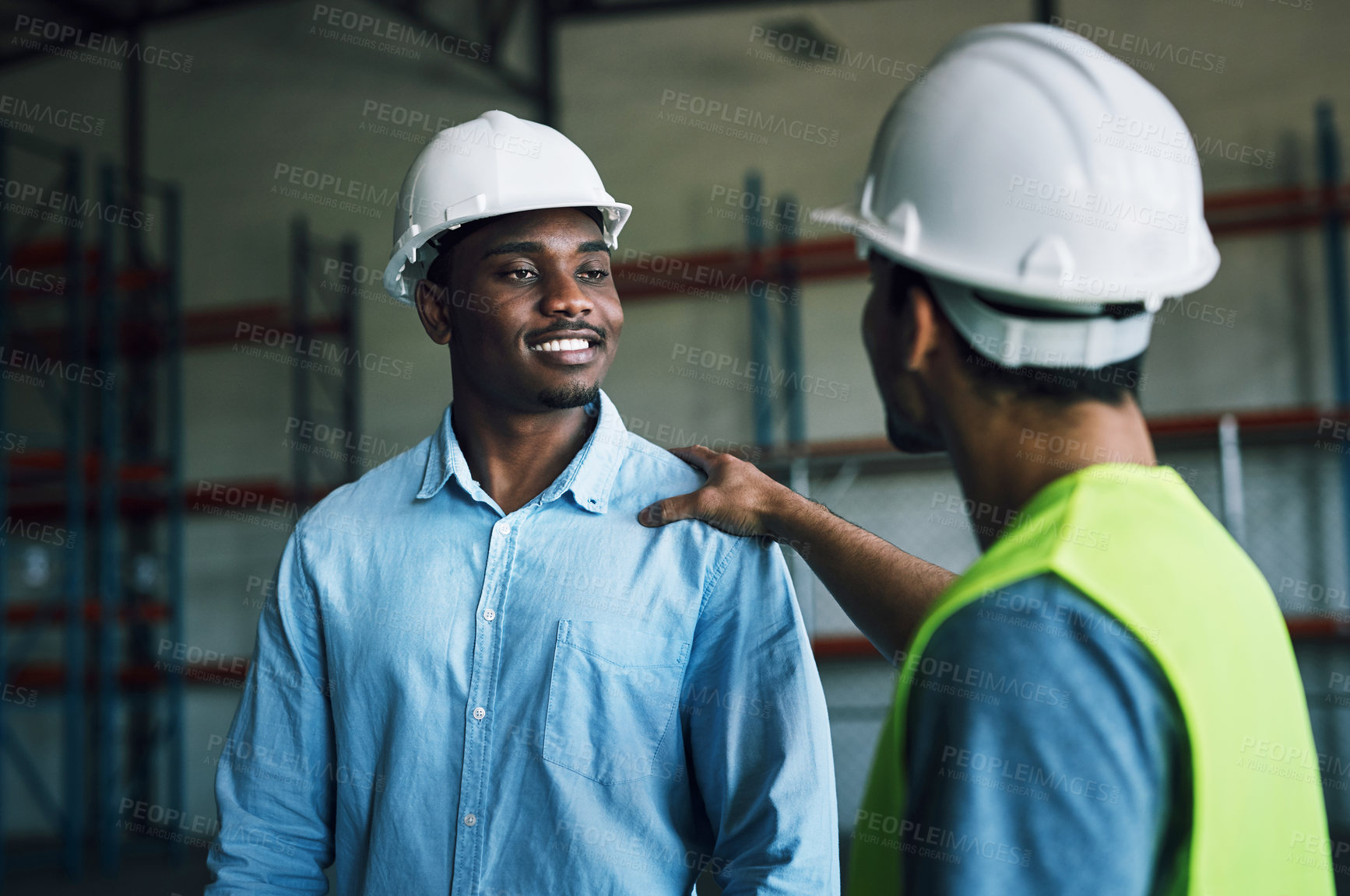 Buy stock photo Shot of two having a conversation in a warehouse