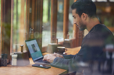 Buy stock photo Man, laptop and typing in cafe for remote work by window, profile or creativity for online media agency. Writer, computer and reading screen for story, editing or freelance copywriting in coffee shop