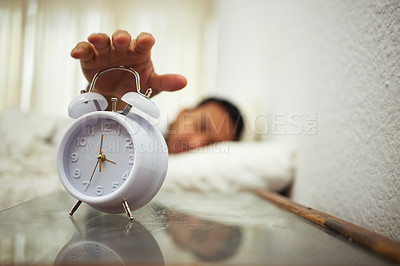 Buy stock photo Shot of a man reaching for his alarm clock