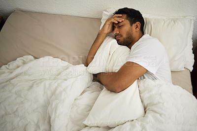 Buy stock photo Sleeping problem, headache and man in bed with pillow at home with insomnia and fatigue. Morning, male person and house feeling frustrated and sad from pain and sleep issue with blanket in bedroom
