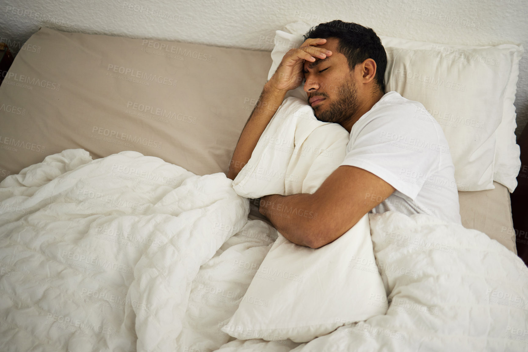 Buy stock photo Sleeping problem, headache and man in bed with pillow at home with insomnia and fatigue. Morning, male person and house feeling frustrated and sad from pain and sleep issue with blanket in bedroom