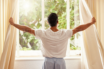 Buy stock photo Back view, man and open curtain at window to good morning, sunrise and sunshine to relax in room at home. Guy, wake up and opening bedroom drapes in apartment for sunlight, fresh air or start new day