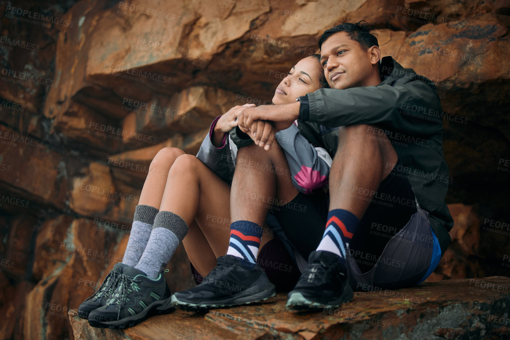 Buy stock photo Shot of a young couple admiring the view while out hiking together