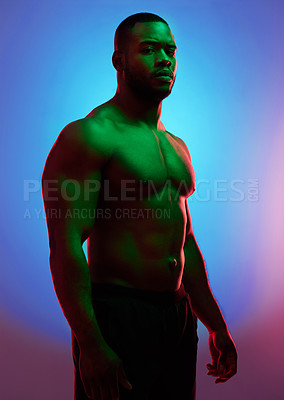 Buy stock photo Studio shot of a man posing shirtless against a neon background