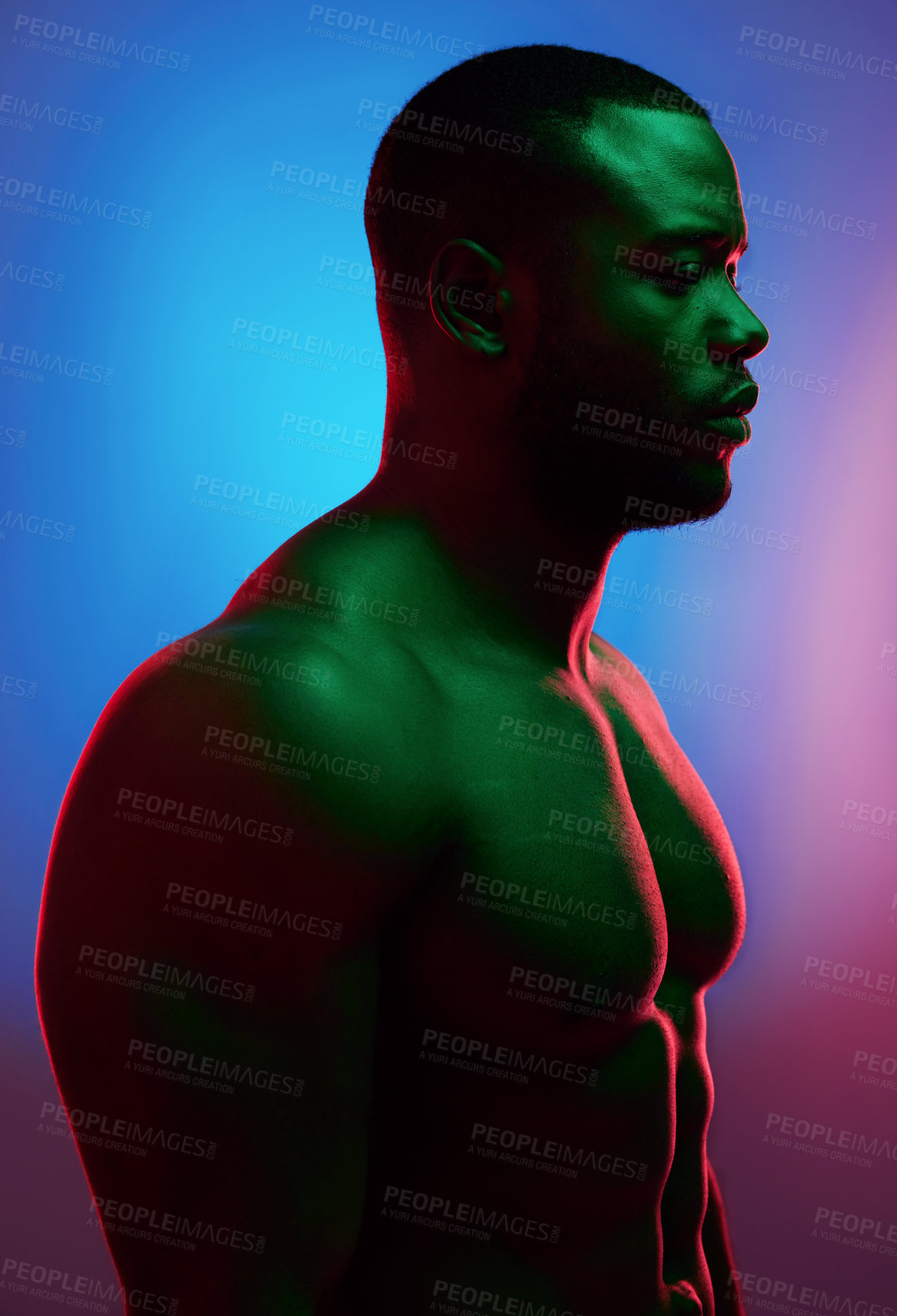 Buy stock photo Studio shot of a man posing shirtless against a neon background