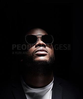 Buy stock photo Black man, thinking and fashion with sunglasses for serious idea of goal isolated in studio. African male person, eyewear and shadow with trendy clothes and vision for music career on dark background