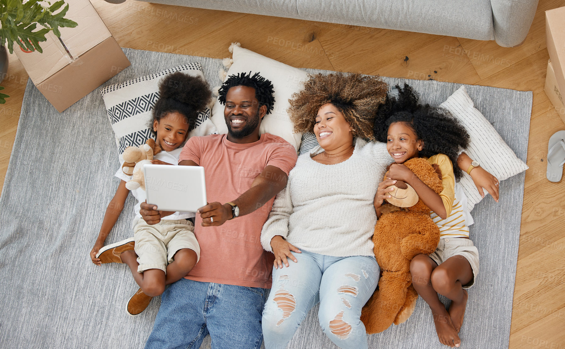 Buy stock photo Family, tablet and playing games on living room floor together in home for entertainment, bonding and fun. Happy, parents and children with tech in house for learning, development or streaming videos