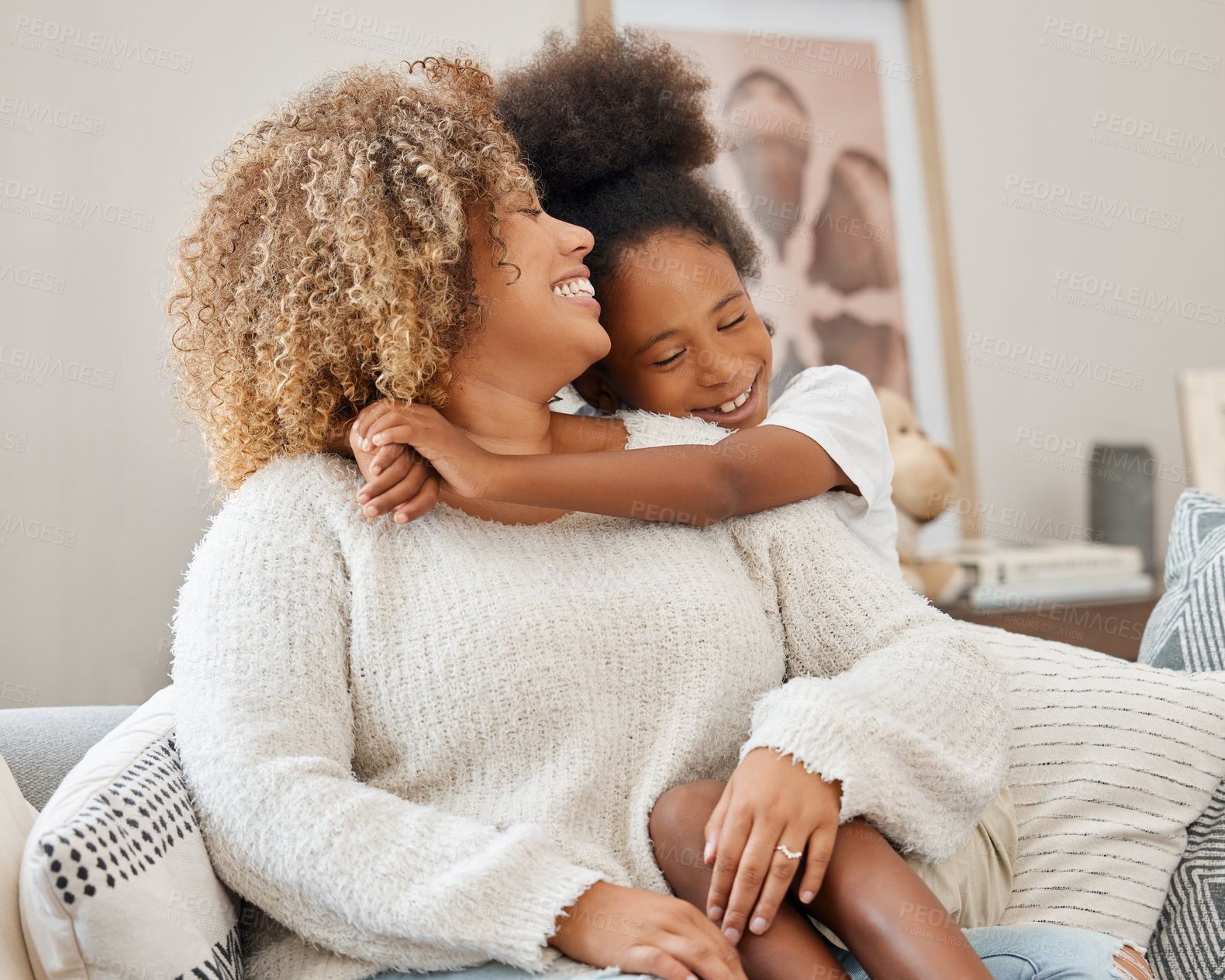 Buy stock photo Shot of a mother and daughter sitting on the couch