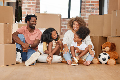 Buy stock photo Shot of a family sitting on the floor in their new home