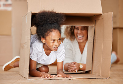 Buy stock photo shot of a mother playing with her daughter in a box at home