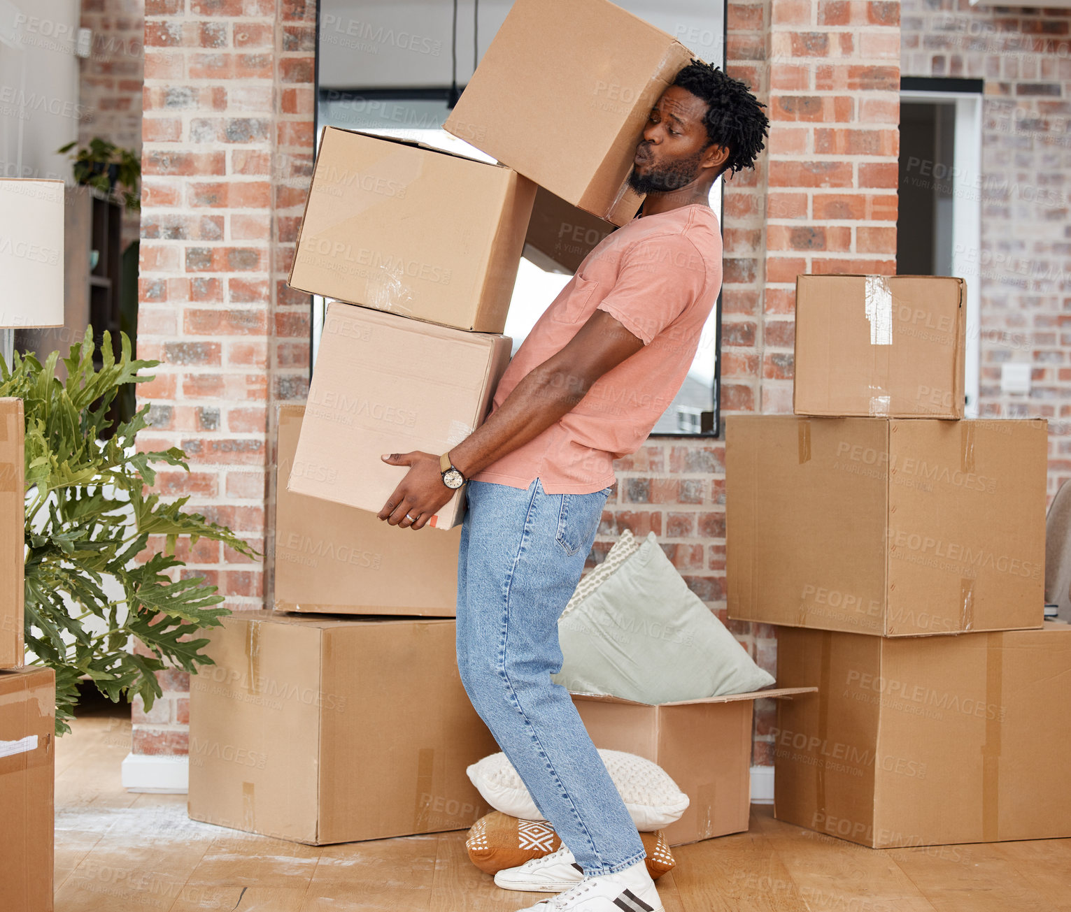 Buy stock photo Shot of a man carrying boxes into his new home