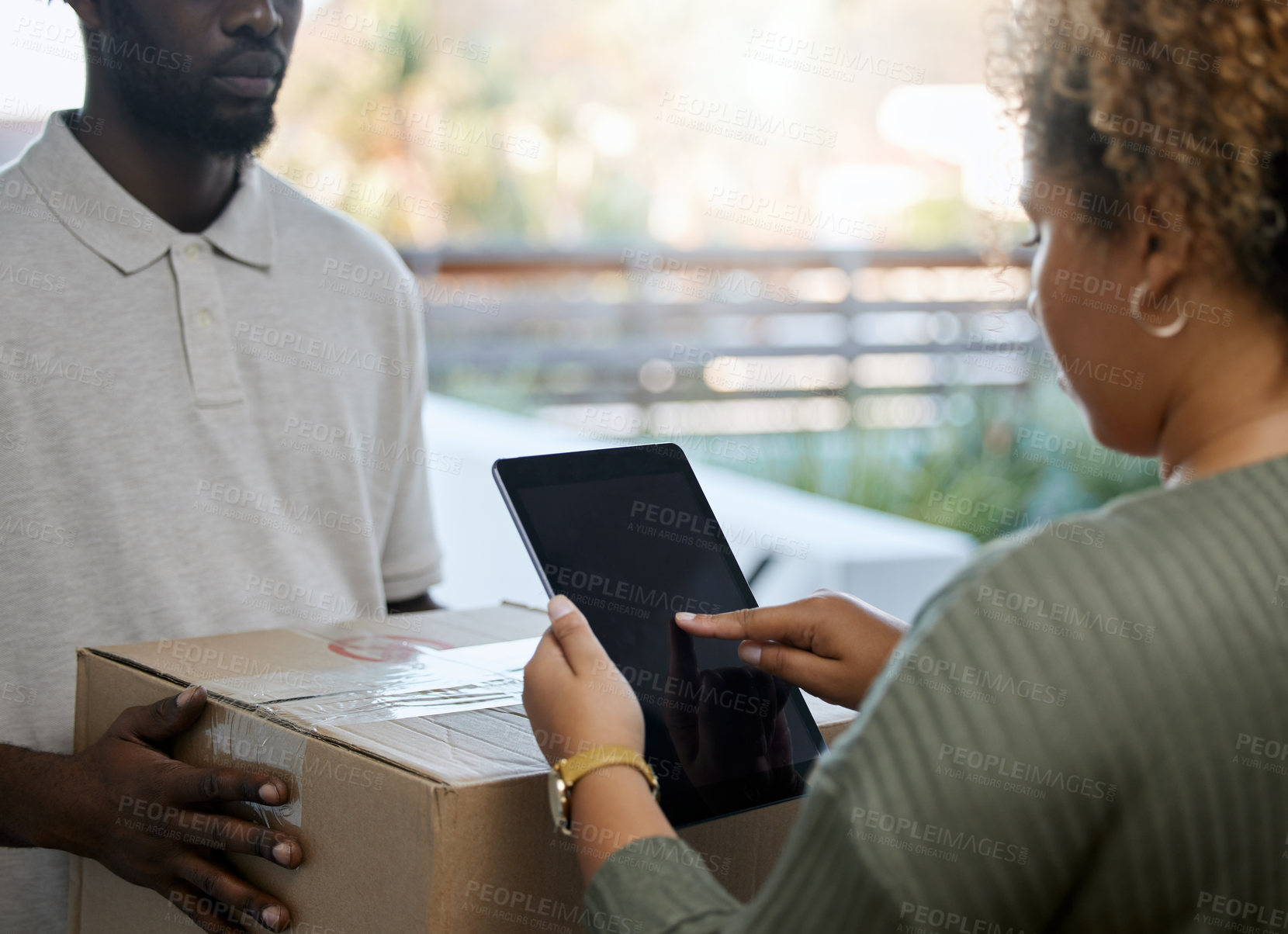Buy stock photo Shot of a unrecognizable woman receiving a box from a deliveryman at home