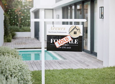 Buy stock photo Shot of for sale sign with a sold sticker outside a house