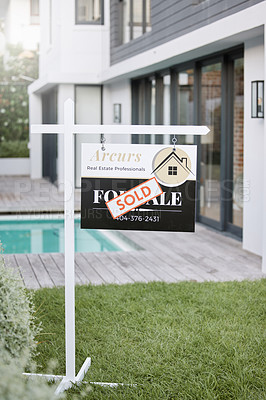 Buy stock photo Shot of for sale sign with a sold sticker outside a house