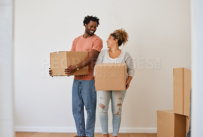 Buy stock photo Shot of a young couple moving in to their new home