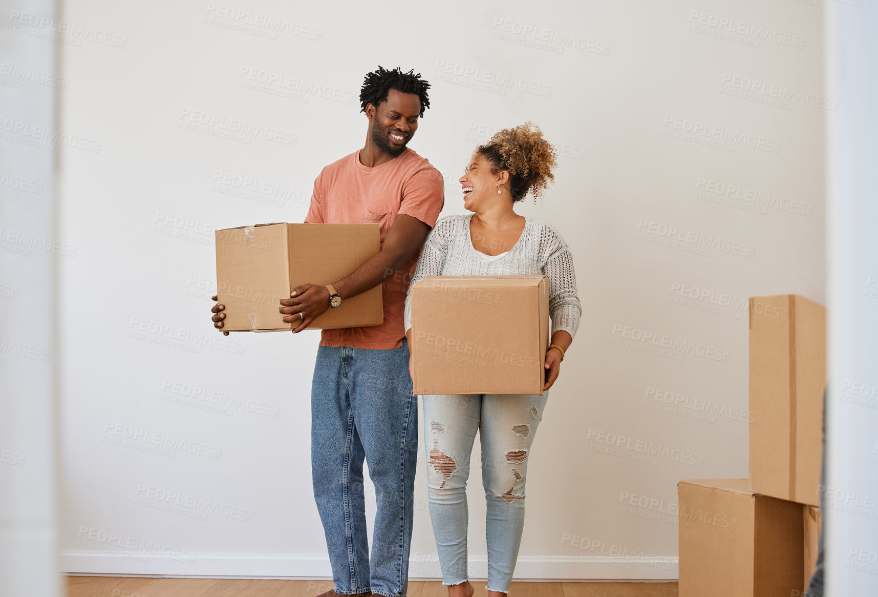 Buy stock photo Shot of a young couple moving in to their new home