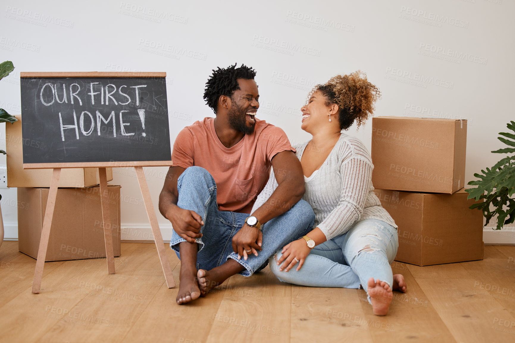 Buy stock photo Board, box or happy couple laughing in new house in real estate, property investment or buying apartment. Our first home, words or man on floor with smile, sign or woman to celebrate moving in rent