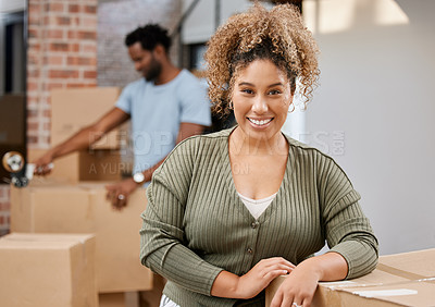 Buy stock photo Shot of a woman leaning on boxes at home