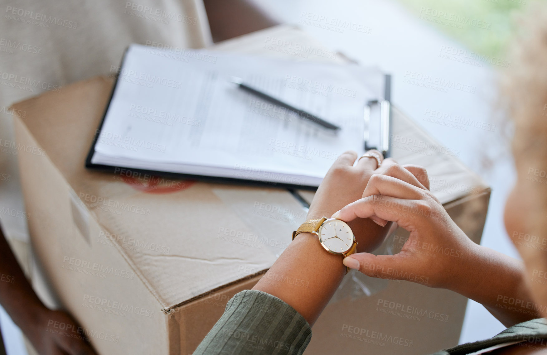 Buy stock photo Shot of a unrecognizable woman receiving a box from a deliveryman at home