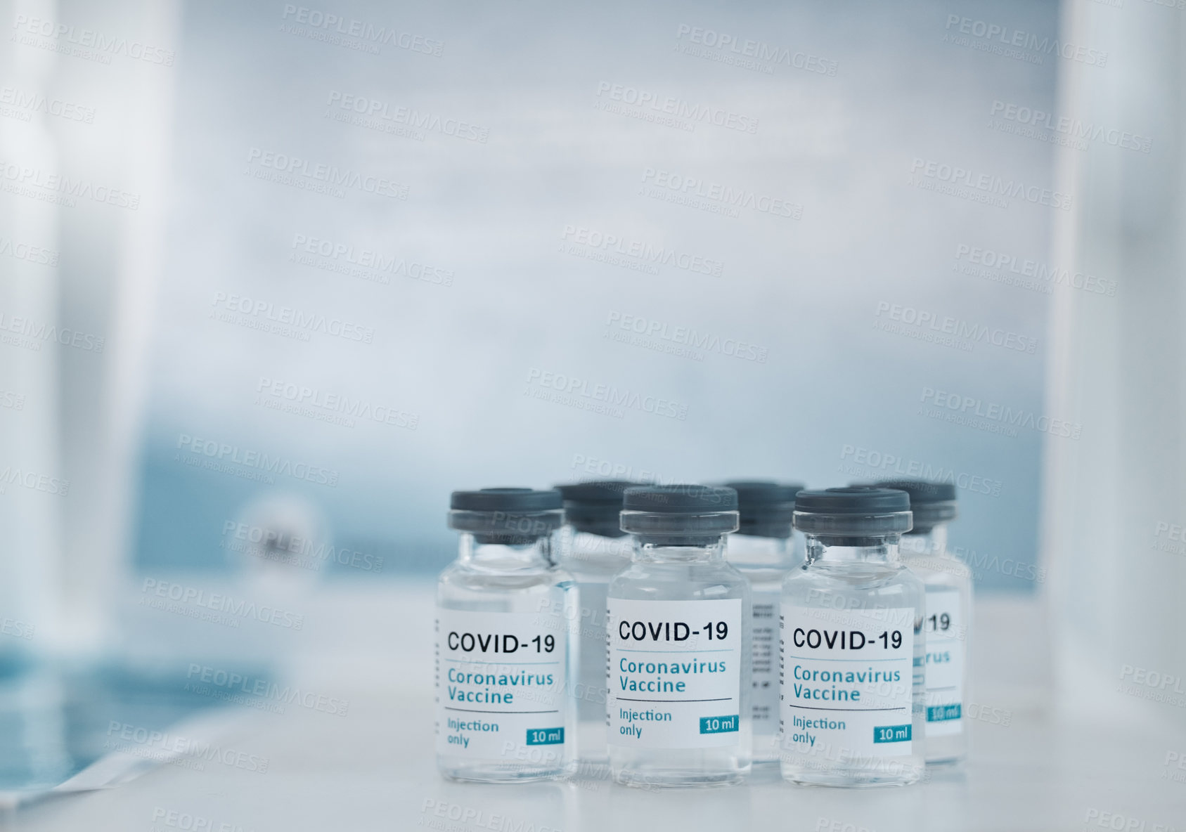 Buy stock photo Vial, covid 19 and drugs on table for healthcare, relief or prescription medicine for virus at the hospital. Container or bottle of development, vaccine and pharmaceutical liquid for research illness