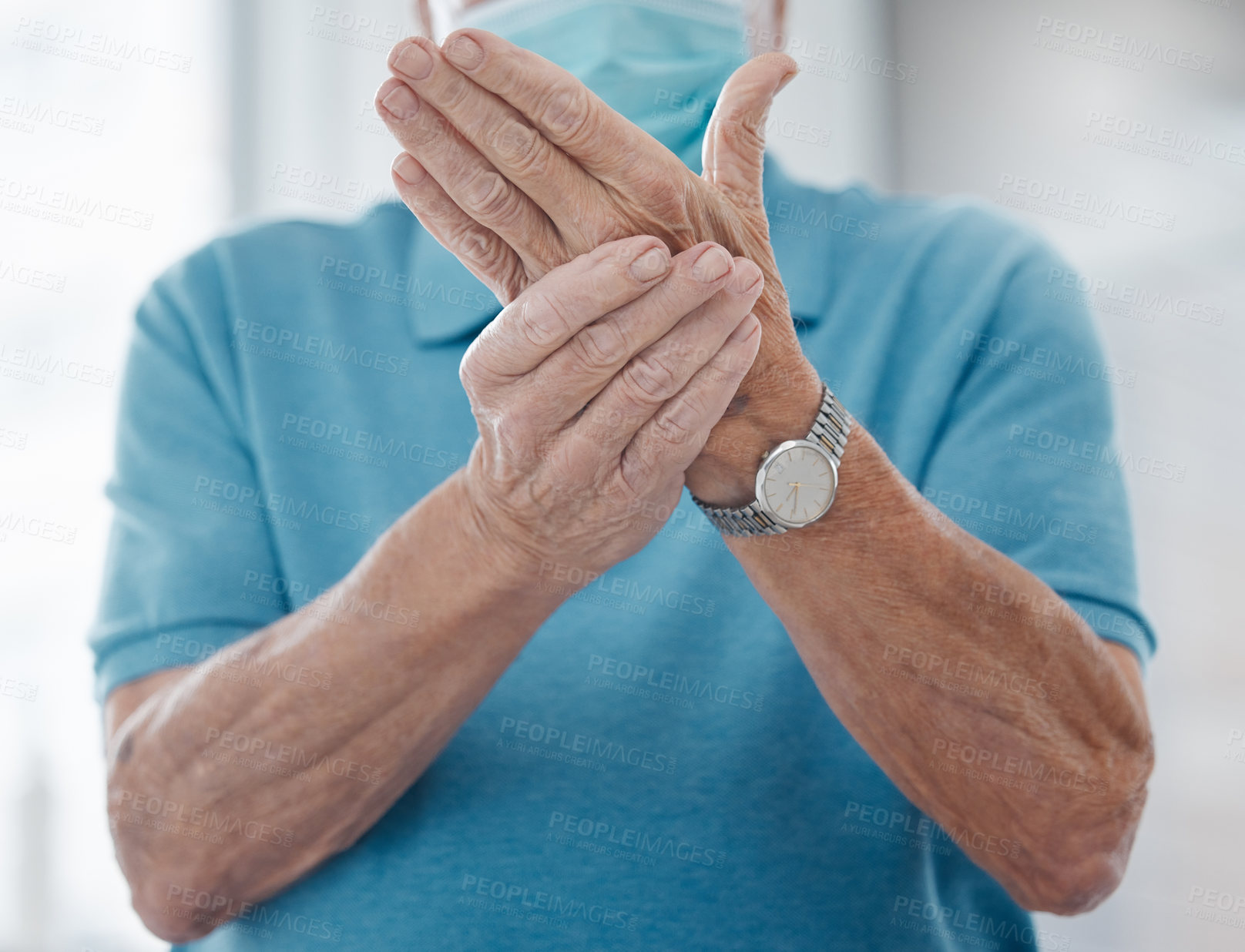 Buy stock photo Shot of an unrecognizable man feeling his hands in a hospital