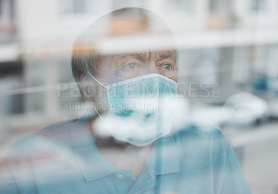 Buy stock photo Shot of a mature man looking out a window in a hospital