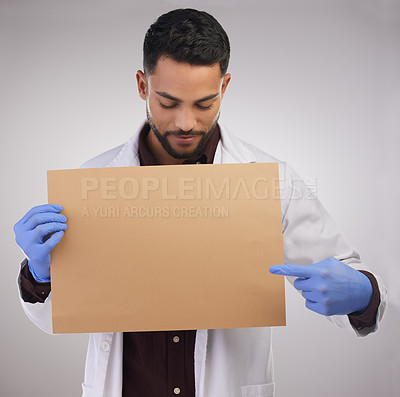 Buy stock photo Sign, man and doctor pointing at poster for healthcare, advertising or mockup isolated on white studio background. Scientist, banner or medical professional on board to show blank space for marketing