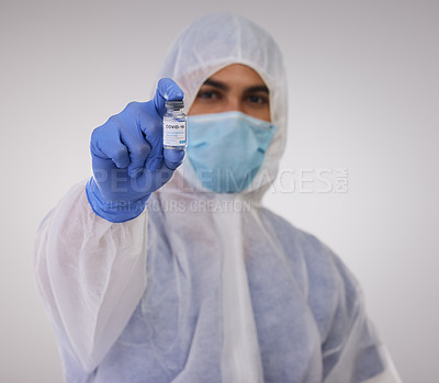 Buy stock photo Healthcare, vial and doctor with vaccine in studio with face mask, gloves and biohazard suit. Injection, portrait and male medical person with vaccination for virus prevention by white background.