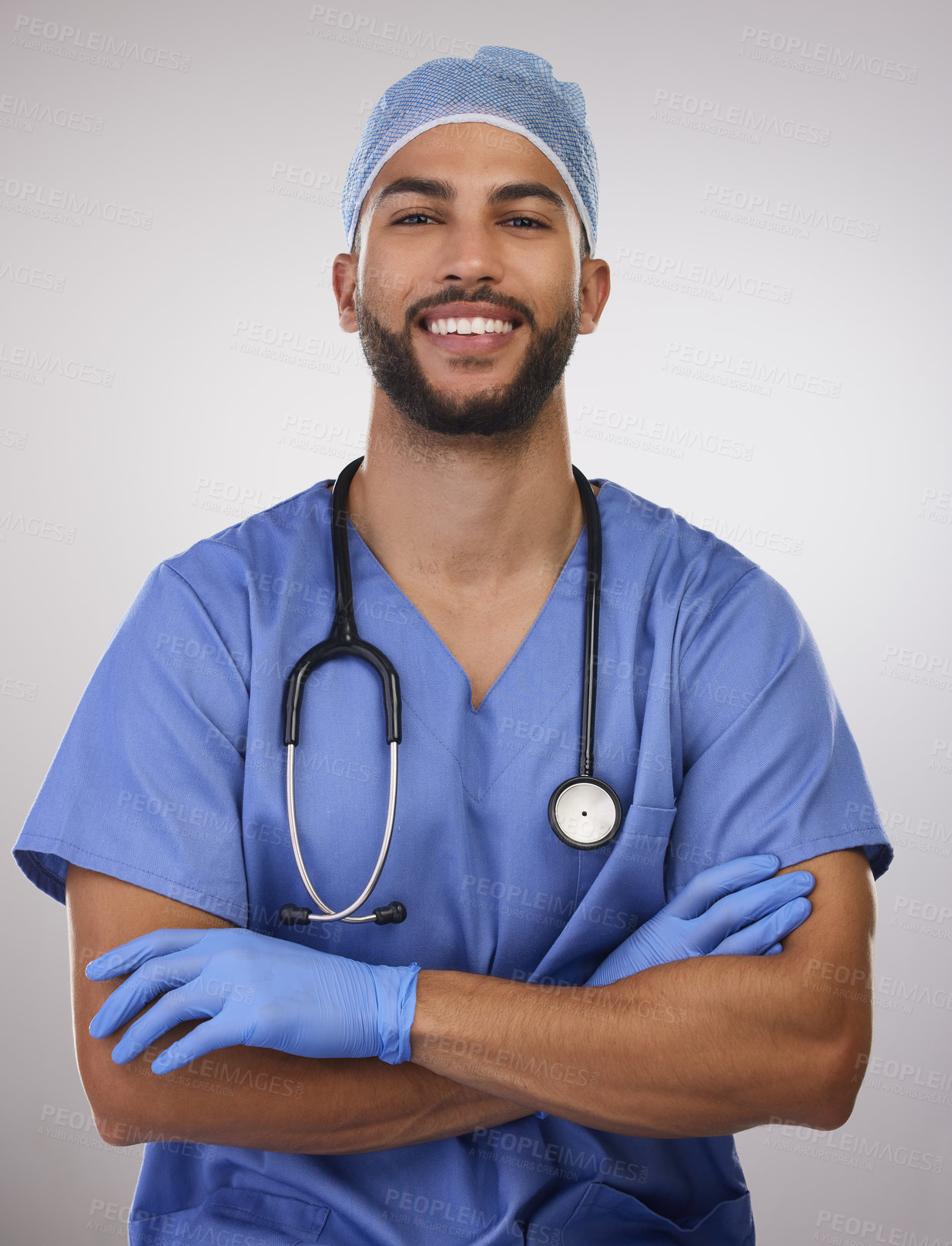 Buy stock photo Doctor, studio portrait and happy man with pride for patient health, cardiology expert and gloves for safety. Male surgeon, stethoscope and confidence for heart surgery and protection for hygiene