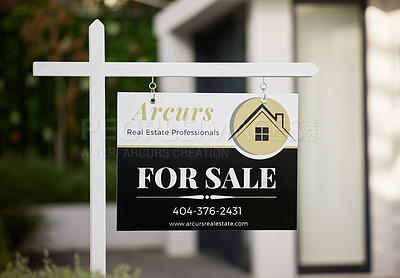 Buy stock photo A for sale sign outside of a house in the real estate industry. On the market for a new home in a residential area. Contact your realtor about moving out and relocating to a luxury apartment