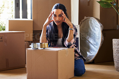Buy stock photo Shot of a young woman packing up to move
