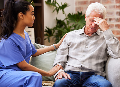 Buy stock photo Shot of a young female nurse giving her elderly patient support