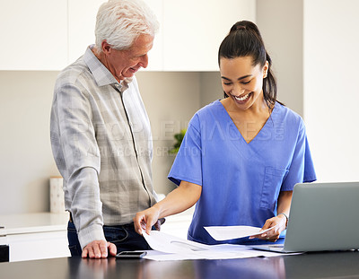 Buy stock photo Shot of a nurse going over paperwork with her senior patient
