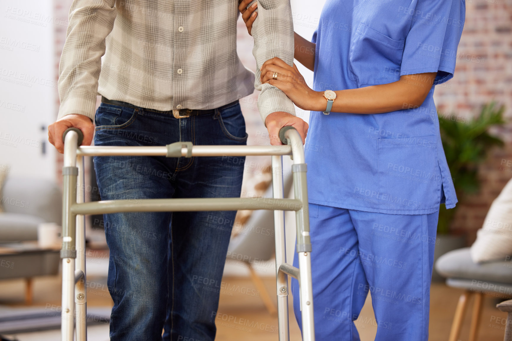 Buy stock photo Shot of a nurse helping her elderly patient use their walking frame