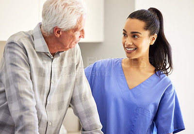 Buy stock photo Shot of a young female nurse with her mature patient