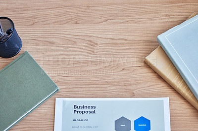 Buy stock photo High angle shot of paperwork and a notebook on a desk in an empty office during the day