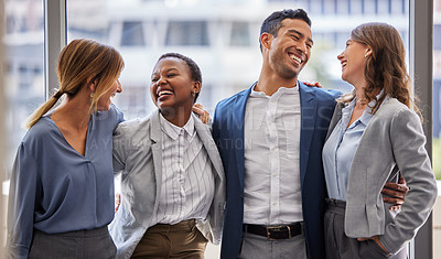 Buy stock photo Shot of a diverse group of businesspeople standing close together in the office and laughing