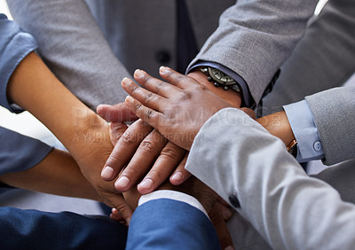 Buy stock photo Cropped shot of a diverse group of businesspeople standing together in the office with their hands piled in the middle
