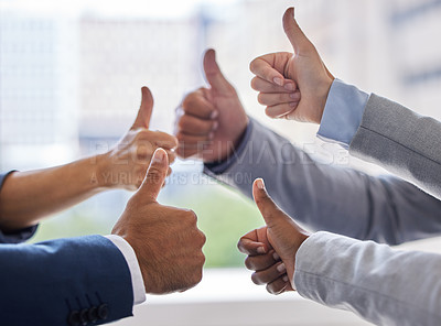 Buy stock photo Cropped shot of an unrecognizable group of businesspeople standing together in the office and making a thumbs up gesture