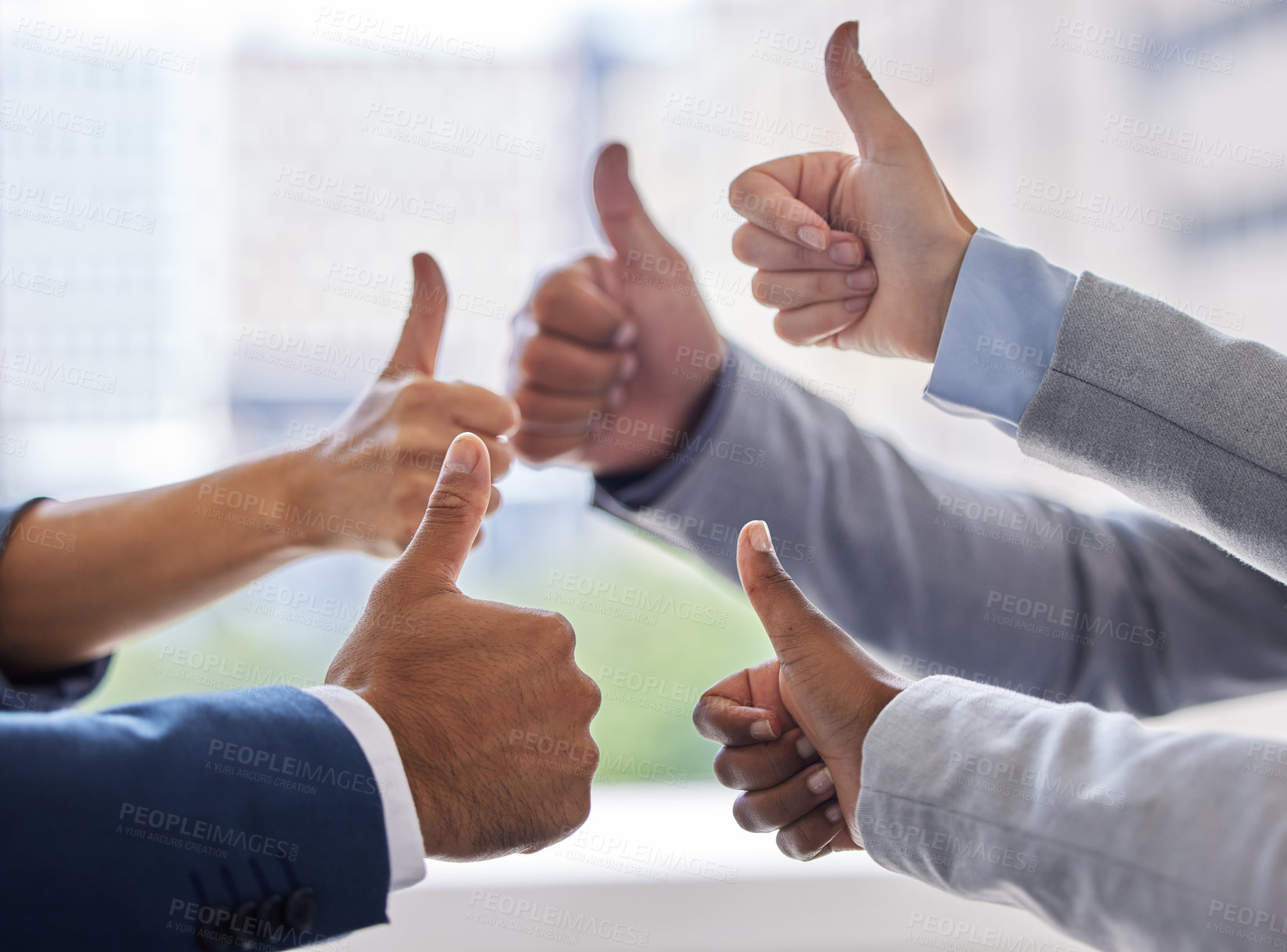 Buy stock photo Cropped shot of an unrecognizable group of businesspeople standing together in the office and making a thumbs up gesture
