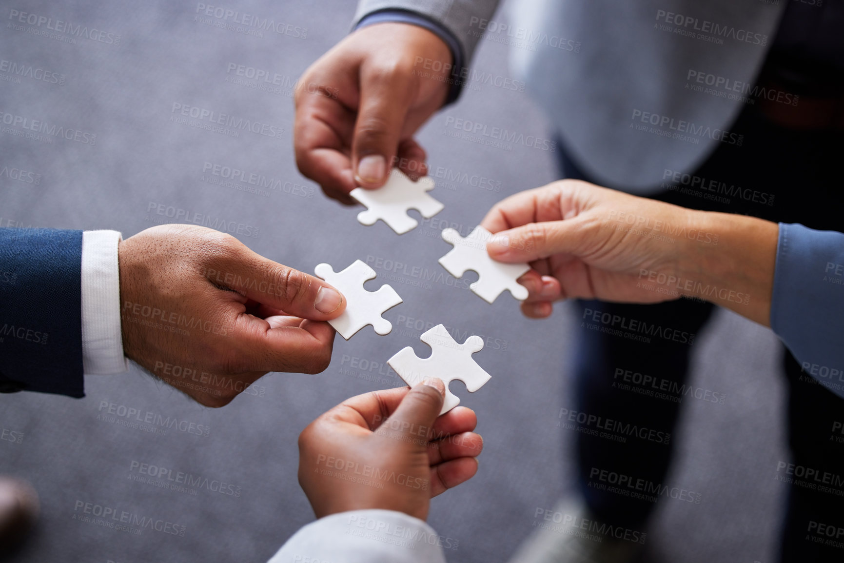 Buy stock photo Businesspeople, collaboration and puzzle with hands in office for teamwork or synergy with joint effort. Group, corporate and partnership with unity in company or trust with employees in Germany.