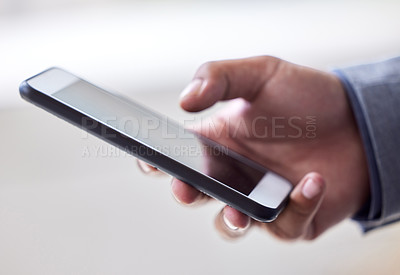Buy stock photo Cropped shot of an unrecognizable man using his cellphone