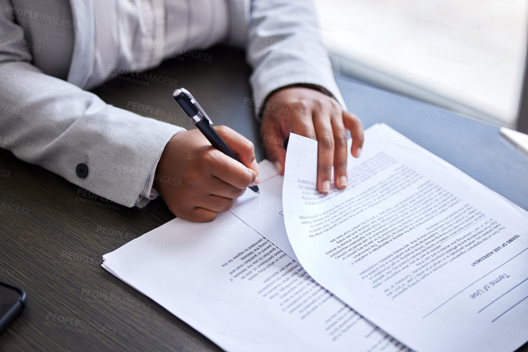 Buy stock photo Cropped shot of a businesswoman signing paperwork in an office