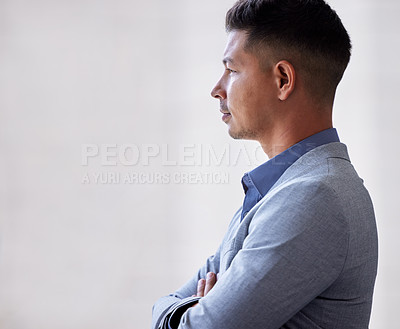 Buy stock photo Shot of a businessman looking thoughtful while standing in an office