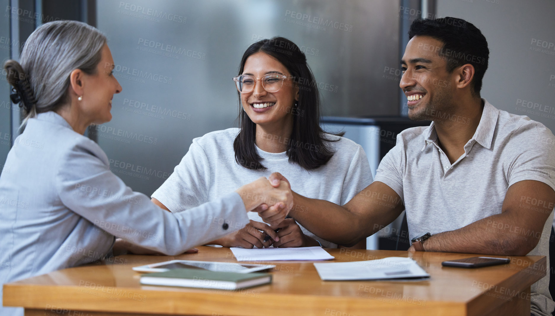 Buy stock photo Smile, couple and handshake with financial consultant for deal, agreement or contract. Happy, man and woman shaking hands of broker for finance, loan or mortgage, welcome and thank you for investment