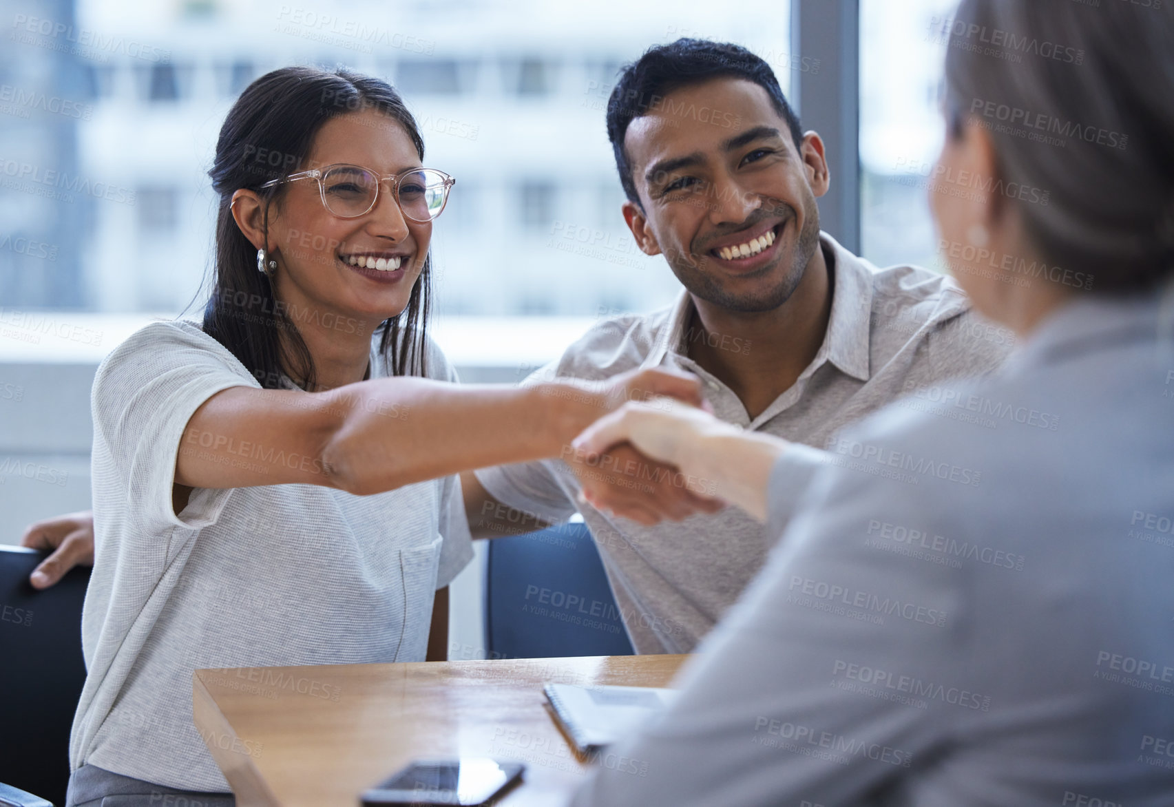 Buy stock photo Couple, happy and handshake with financial consultant for deal, agreement or contract. Smile, man and woman shaking hands of broker for finance, loan or mortgage, welcome and thank you for investment