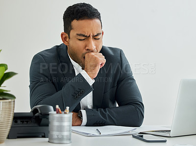 Buy stock photo Shot of a tired businessman yawning at his desk in a modern office